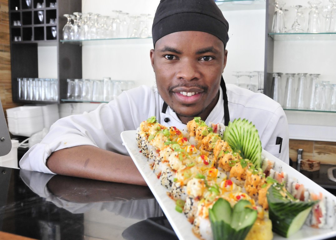 Sunninghill square | Johannesburg, Sandton, Mall, Shopping Centre, Convenient, Near Me, South African, Local, Affordable, Quality Master Sushi at the square, African chef holding sushi plate