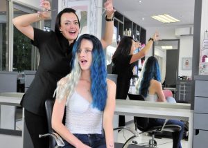 Sunninghill square | Johannesburg, Sandton, Mall, Shopping Centre, Convenient, Near Me, South African, Local, Affordable, Quality Colour rush, White millenial with blond and blue hair, hair dresser in all black outfit raising hands in air