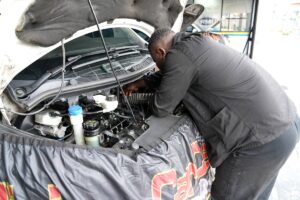 Technician checking under the bonnet at Car Care Clinic, The Square Sunninghill