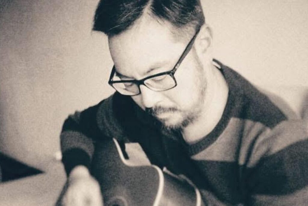 Julian Sun of Henry Ate playing guitar